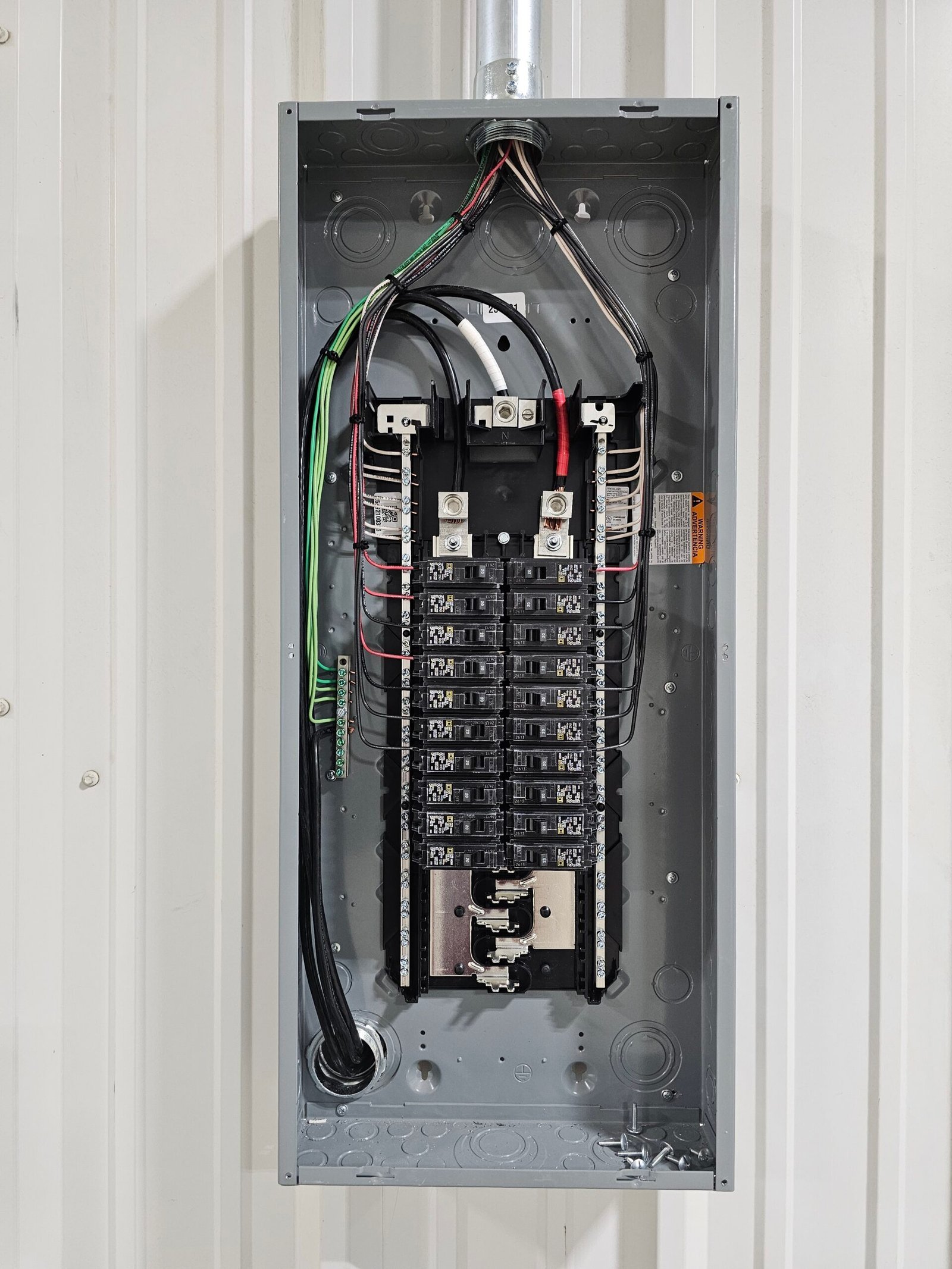 Neatly wired breaker panel on a metal building
